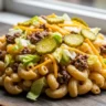 Macro close-up of Big Mac Inspired Pasta Salad with beef, lettuce, pickles, cheese, and special sauce