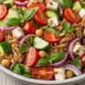 Macro close-up of a Vibrant Mediterranean Orzo Salad with feta, cherry tomatoes, cucumber, and balsamic vinaigrette