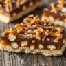 Macro close-up of a piece of Salted Caramel Pretzel Bark showing chocolate, pretzels, caramel, and sea salt