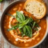 Velvety Vegan Tomato Cannellini Soup in a rustic bowl with fresh basil and crusty bread.