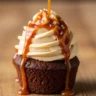 Macro close-up of a decadent Mary Berry Sticky Toffee Cupcake with caramel buttercream and toffee sauce