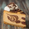 Macro close-up of a slice of Velvet Swirl Espresso Fudge Cheesecake with whipped cream, chocolate shavings, and cocoa powder dusting on a rustic wooden table.