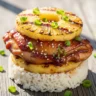 Golden Hawaiian Huli Huli Chicken and Pineapple Stacks served over jasmine rice, garnished with green onions and sesame seeds.