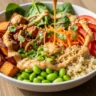 Macro close-up of a vibrant Creamy Thai Peanut Sweet Potato Nourish Bowl drizzled with rich peanut sauce.
