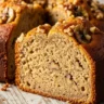 Macro close-up of a moist slice of Easy Vanilla Banana Walnut Cake with visible walnuts and a golden crust.