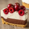 Macro close-up of a slice of Effortless Decadent Chocolate Cherry Cloud Pie showing layers of chocolate, cream, and cherries.