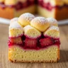 Macro close-up of a slice of Norwegian Rhubarb Bliss cake, showcasing its tender crust, vibrant rhubarb filling, and powdered sugar dusting.